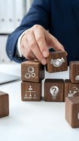 Businessman hand placing wooden cube with handshake icon representing partnership and teamwork in corporate strategy building blocks concept.