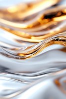 Abstract flowing curves in gold and silver metallic tones create elegant wave pattern with smooth glossy texture and soft light reflections for luxury backgrounds.