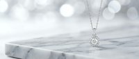 Silver pendant necklace with crystal gemstone on marble surface with soft bokeh lighting for luxury jewelry photography and elegant fashion accessories.