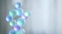 Floating translucent soap bubbles with iridescent rainbow colors against soft blurred background for relaxation and wellness concepts.