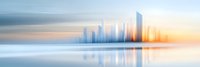 Modern city skyline reflection on calm water surface at sunrise, with soft pastel colors and motion blur effect creating dreamy urban landscape panorama.