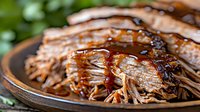 Grilled portobello mushrooms with caramelized glaze on wooden plate. Fresh vegetarian barbecue dish with golden brown caps and savory coating for healthy dining.