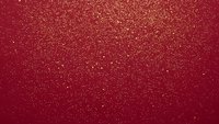 Red glitter texture background with sparkling golden particles for holiday decorations, Christmas cards, festive designs and luxury presentations.