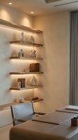 Modern living room interior with illuminated floating wooden shelves displaying decorative vases and books on white wall near comfortable seating area.