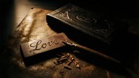 Wooden plaque with carved word Love beside engraved book and carving tool on rustic dark surface, warm moody lighting.