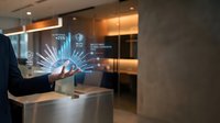 Businessman using holographic digital interface technology in modern office environment with futuristic data visualization and connectivity graphics.
