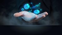 Businessman hand holding glowing digital financial icons with upward trending graphs, representing growth, investment analysis, and data-driven business strategy for corporate finance solutions.