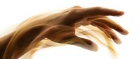 Human hand reaching forward with flowing golden light energy waves on white background, symbolizing touch, healing, and spiritual power.