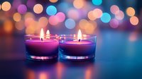 Glowing purple and blue scented candles with soft bokeh lights in background creating romantic atmosphere for spa, meditation, or holiday decoration.
