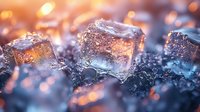 Glowing ice cubes with orange and blue light effects on dark background, macro photography showing frozen crystal structure and water drops with bokeh illumination.