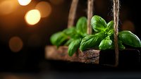 Fresh basil leaves on rustic wooden swing with warm bokeh lights in dark background, moody food photography composition.
