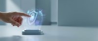 Hand touching holographic security shield icons emerging from modern device on clean white surface representing cybersecurity protection and digital safety technology.