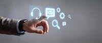 Business hand touching digital customer service icons with headset, email and support symbols on gray background for tech communication solutions.