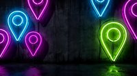 Colorful neon location pin icons glowing against dark concrete wall background for navigation apps, mapping services, and digital marketing materials.
