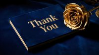 Elegant navy blue thank you card with gold foil lettering beside a luxurious golden rose on rich velvet fabric for premium gifting.
