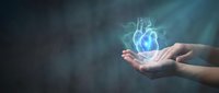 Hands holding glowing blue heart hologram against dark background representing healthcare technology, medical innovation and cardiology concepts for digital health.