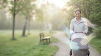 Young Caucasian woman in wheelchair smiling confidently in sunny park setting with trees and pathway, representing disability inclusion and mobility.