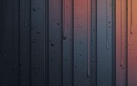Raindrops streaming down window glass create vertical lines against moody sunset background, capturing melancholic atmosphere in dark blue and coral tones.