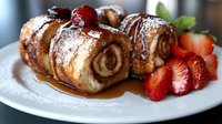 Freshly baked cinnamon rolls dusted with powdered sugar, served with sliced strawberries and caramel sauce on white plate for bakery, dessert, and breakfast content.