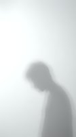 Blurred silhouette of person behind frosted glass creating mysterious shadow effect for privacy and anonymity concepts in monochrome style.