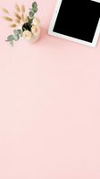 Flat lay workspace with tablet, cream roses, eucalyptus, and pampas grass on soft pink background. Perfect for web design, blogging, and digital marketing projects.