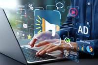 Digital marketing concept with businessman hands typing on laptop surrounded by floating advertising icons megaphone analytics charts and social media symbols.