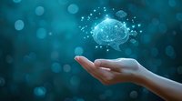 Digital brain hologram floating above female hand against turquoise bokeh background, representing artificial intelligence, machine learning and cognitive technology advancement.