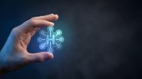 Hand holding glowing neon interconnected nodes symbol representing digital network, technology integration, data connection, and system management solutions.