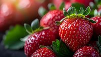 Fresh ripe strawberries with green leaves close up macro shot on dark background. Vibrant red berries with natural texture and juicy appearance.