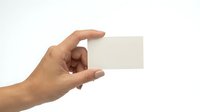 Hand holding blank white business card mockup on transparent background isolated for branding design projects and corporate identity presentations.