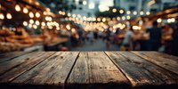 Rustic wooden table with blurred night market or festival in background, warm string lights creating festive atmosphere.