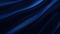Luxurious dark blue silk fabric with elegant waves and folds creating dramatic light effects and shadows against deep navy background, suitable for luxury design projects.