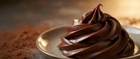 Rich chocolate frosting swirl on golden spoon with cocoa powder, warm lighting creates luxurious dessert atmosphere for bakery and culinary projects.