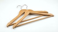 Wooden clothes hangers with chrome hooks on white background, isolated for wardrobe organization, retail display, and home storage concepts.