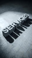 Bold concrete SERVICES letters casting dramatic shadows on a textured gray floor, conveying strength and professionalism for business concepts.