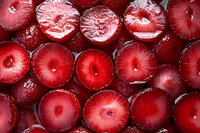 Fresh sliced red radish circles arranged in rows showing vibrant inner pattern and texture, covered with water droplets. Macro food photography.