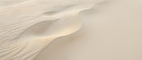 Smooth sand dunes with soft shadows and rippled texture creating an abstract desert landscape. Suitable for backgrounds, travel designs, and nature-themed projects.