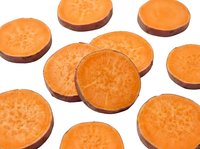 Fresh sweet potato slices cut in rounds showing vibrant orange flesh, isolated on white background for healthy cooking and nutrition designs.