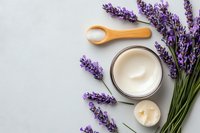 Fresh lavender flowers with natural organic cream and wooden spoon on light gray background. Spa and wellness composition for beauty treatment.