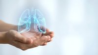 Holographic lungs floating above open hands representing respiratory health, medical care, and pulmonary system protection in healthcare concept.