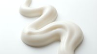 Creamy white cosmetic product swirl isolated on light background, suitable for skincare, beauty packaging, and wellness design applications.