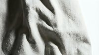 Crumpled beige linen fabric with natural folds and shadows, suitable for textile backgrounds, fashion design mockups, and interior styling projects.