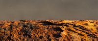 Cracked earth surface with deep fissures and rust-colored soil texture, suitable for environmental, climate change, drought, and geological design projects.