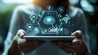 Digital brain with glowing icons floating above tablet device held by hands, representing artificial intelligence, machine learning and smart technology in modern business.