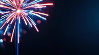 Vibrant red and blue fireworks burst against dark night sky with bokeh light effects, creating patriotic celebration atmosphere. Festive pyrotechnic display.