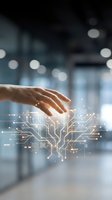 Human hand reaching toward glowing digital circuit board pattern with bokeh lights in modern office environment representing technology innovation and connectivity.