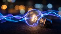 Glowing light bulb with electric energy waves on dark surface against blurred city lights background for innovation and creativity concepts.