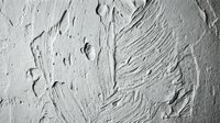 White textured paint strokes on canvas surface with thick impasto technique creating abstract artistic background for creative projects and design work.