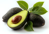 Fresh ripe avocados with green leaves isolated on white background. Healthy organic fruit cut in half showing pit. Natural superfood ingredient.