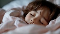 Young Asian woman sleeping peacefully in soft pink bedding, natural morning light creates gentle shadows across serene face, dreamy bedroom atmosphere.